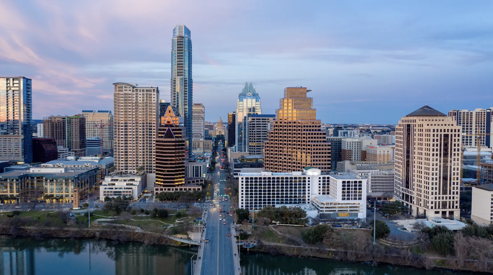 Aerial looking up Congress Avenue toward downtown Austin at twilight