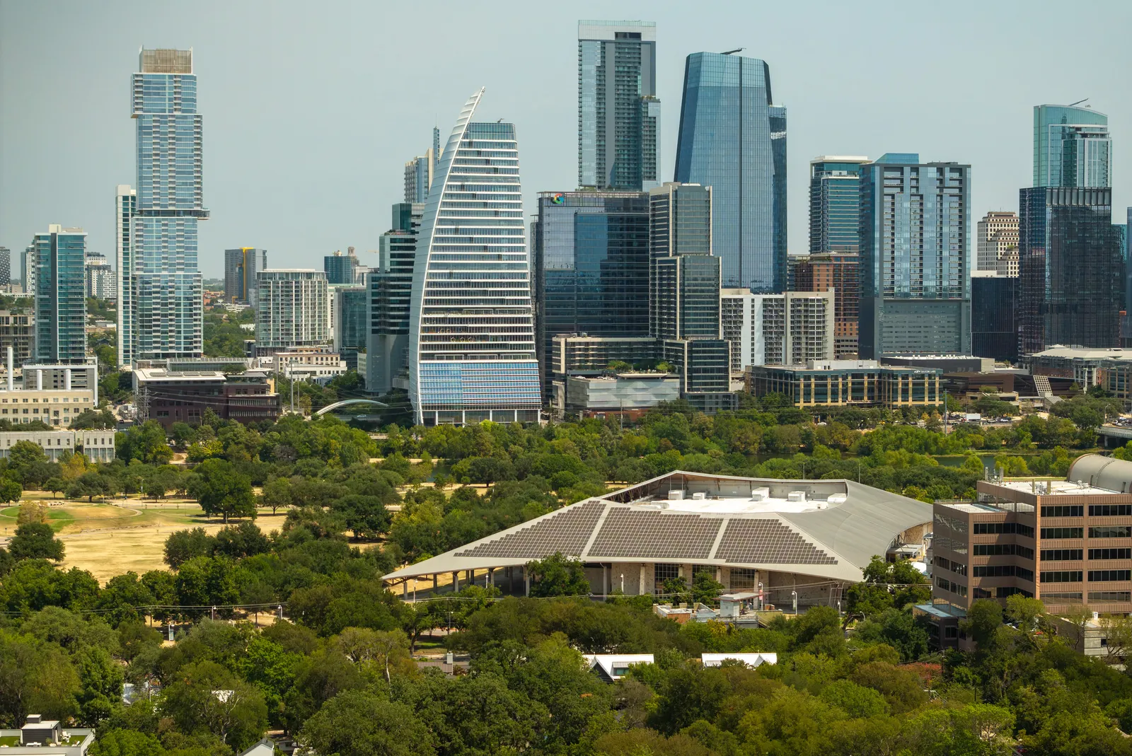 Daytime aerial of downtown Austin towers above the Palmer Events Center
